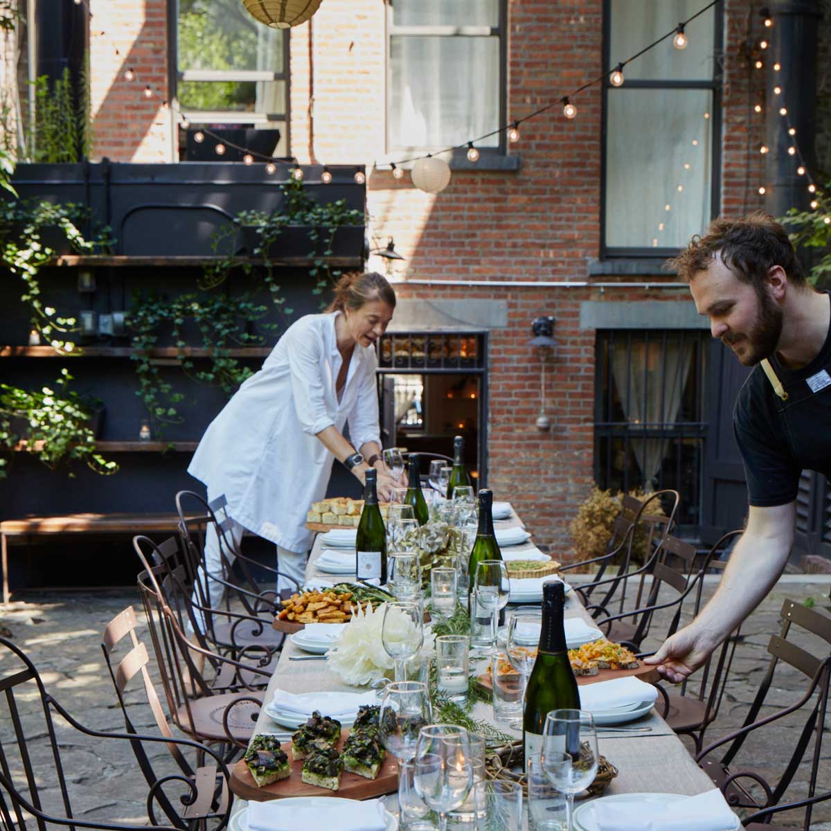 Setting up a romantic Wedding dinner in a intimate Brooklyn Garden Venue.