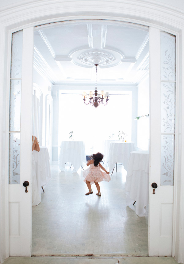 A little girl jumping joyfully on the Parlor during a Wedding at an intimate Brooklyn Brownstone.